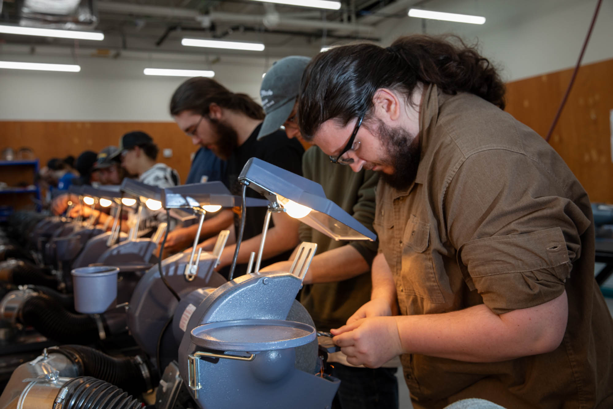 Students work on grinding wheels in the machining lab